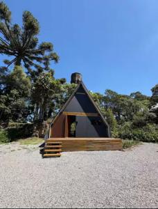 a small tent with a door on a gravel field at Hospedagem de Charme Te Amo in Canela