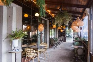 a restaurant with tables and chairs and potted plants at Alda Carballo in Carballo