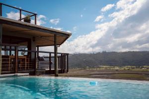 a swimming pool in front of a house at Interlaken Guest House in Wilderness