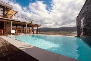 a swimming pool on the side of a building at Interlaken Guest House in Wilderness