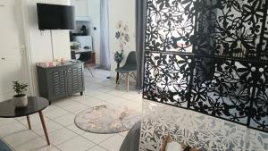 a living room with a black and white patterned wall at Welcome studio in Preveza