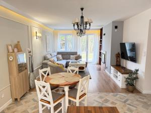 a living room with a table and a couch at Borki Guest House in Smardzewice