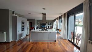 a kitchen with an island in the middle of a room at Unique and special loft in Sant Joan de les Abadesses