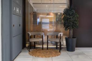 a room with a table and chairs and a potted plant at Hotel America Igualada in Igualada