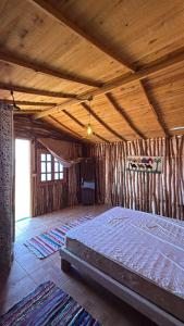 a large bedroom with a bed in a room with wooden ceilings at Anne in Nuweiba