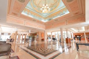 a large lobby with a chandelier in a building at Golden Carthage Hotel & Residence Tunis in Gammarth +45 photos