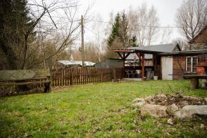 a house with a wooden fence in a yard at Apartament nad Bukówką in Lubawka +13 photos
