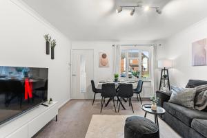 a living room with a couch and a table at The Derby Escape - Garden -Sleeps 6 in Derby