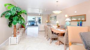 a dining room and living room with a table and chairs at 115 Mariners Club in Key Largo