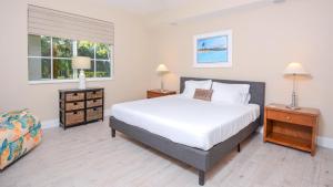 a bedroom with a white bed and two night stands at 115 Mariners Club in Key Largo +44 photos