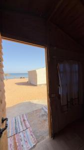 a door to a room with a view of the beach at Anne in Nuweiba