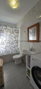 a bathroom with a toilet and a sink at Peñoncillo Beach in Torrox Costa