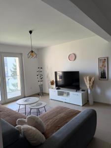 a living room with a couch and a tv at Real Residence Bugojno in Bugojno