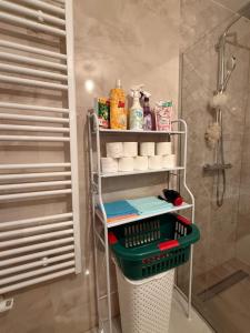 a bathroom with a rack with towels and toiletries at Real Residence Bugojno in Bugojno +12 photos