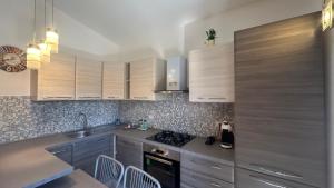 a kitchen with wooden cabinets and a sink and a stove at Casa Rita in San Teodoro +6 photos