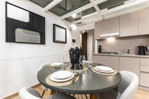 a dining room with a table and chairs in a kitchen at Elisabeth s Loft in Milan +30 photos