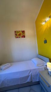 a bedroom with two beds and a painting on the wall at Casa Rita in San Teodoro