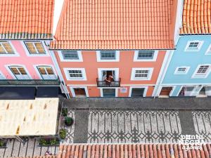 an overhead view of buildings with a person in a window at Angra Soul 1 - By PontaNegraAzores in Angra do Heroísmo
