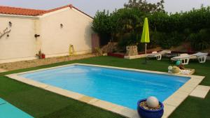 a small swimming pool in a yard with a yard at Au petit lieu-dit in Anglade