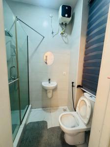 a bathroom with a toilet and a sink at The Jimi Stay in Maiyegun