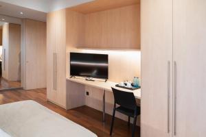 a hotel room with a desk with a television at Hotel America Igualada in Igualada