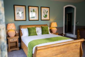 a bedroom with a bed and three pictures on the wall at The Chalk Hare, Royston, Hertfordshire - Acorn Pubs in Royston +51 photos