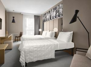a hotel room with two beds with white sheets at Le Meridien Visconti Rome in Rome +143 photos