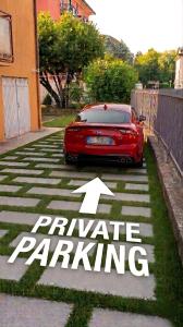a red car parked in a parking lot with an arrow at VENICE Sweet Home - your home in a beautiful neighborhood of the City of Venice in Favaro Veneto