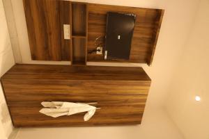 a bathroom with a wooden counter with a towel at Aachman Restaurent in Bulandshahr +18 photos