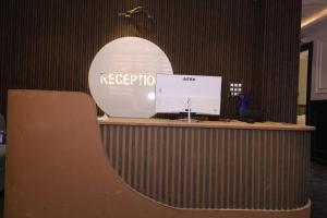 a reception desk in an office with a mirror at Aachman Restaurent in Bulandshahr