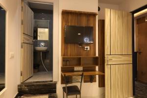 a room with a desk and a television in a room at Aachman Restaurent in Bulandshahr