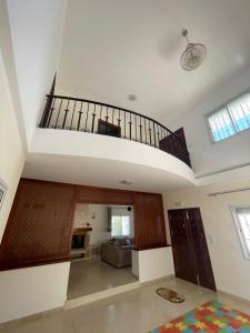 a living room with a staircase in a house at Villa D'or in Ḩammām al Ghazzāz +5 photos