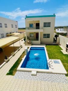 a view of a house with a swimming pool at Villa D'or in Ḩammām al Ghazzāz