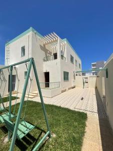 a building with a playground in front of it at Villa D'or in Ḩammām al Ghazzāz