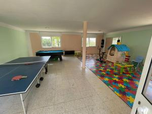 a living room with a ping pong table and a ping pong tableablish at Villa D'or in Ḩammām al Ghazzāz