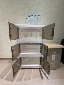 an empty shelf with bottles of water on it at Sonoće Hostel Seoul - Private Bathroom & Premium in Seoul