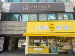 a store with a mecca coffee sign on a building at Sonoće Hostel Seoul - Private Bathroom & Premium in Seoul