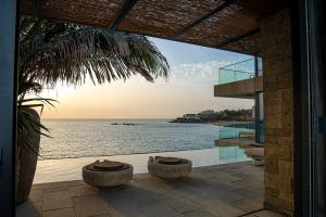 a view of the ocean from a house at Noom Hotel Dakar Sea Plaza, a member of Radisson Individuals in Dakar