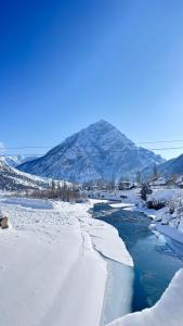 a river covered in snow with a mountain in the background at Gurez knights in Kanzalwan