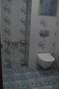 a bathroom with a toilet in the corner of a room at Gurez knights in Kanzalwan