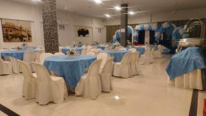 a group of tables and chairs with blue and white table cloth at SunSea Resort in Guimaras +108 photos