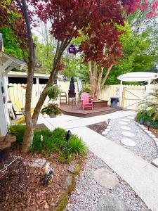a patio with a table and chairs under a tree at Romantic Beach Style Cottage close to everything! in Whitehouse Plantation