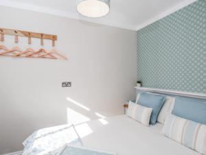 a bedroom with a bed and a wall with polka dots at Firefly Cottage in Cirencester +22 photos