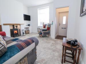 a living room with a couch and a fireplace at 10 South Street in Rossendale