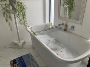 a bath tub with red polka dots in a bathroom at Shelley Cove in Stompneusbaai