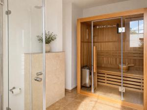 a shower with a glass door in a bathroom at Kapitänshaus Sellin mit Sauna und Kamin in Ostseebad Sellin +27 photos