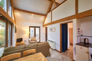 a living room with a couch and a table at Barn Cottages at Lacock in Lacock