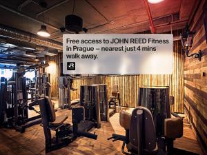 a gym with a sign that reads free access to jolin red fitness in pineapple at Numa Prague Flow in Prague