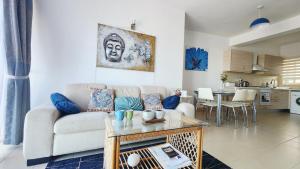 a living room with a couch and a table at Apartament Palm Bay View Esentepe Bahceli in Kyrenia