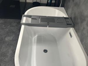 a white bath tub with a speaker on top of it at 3 Linshader in Callernish +13 photos